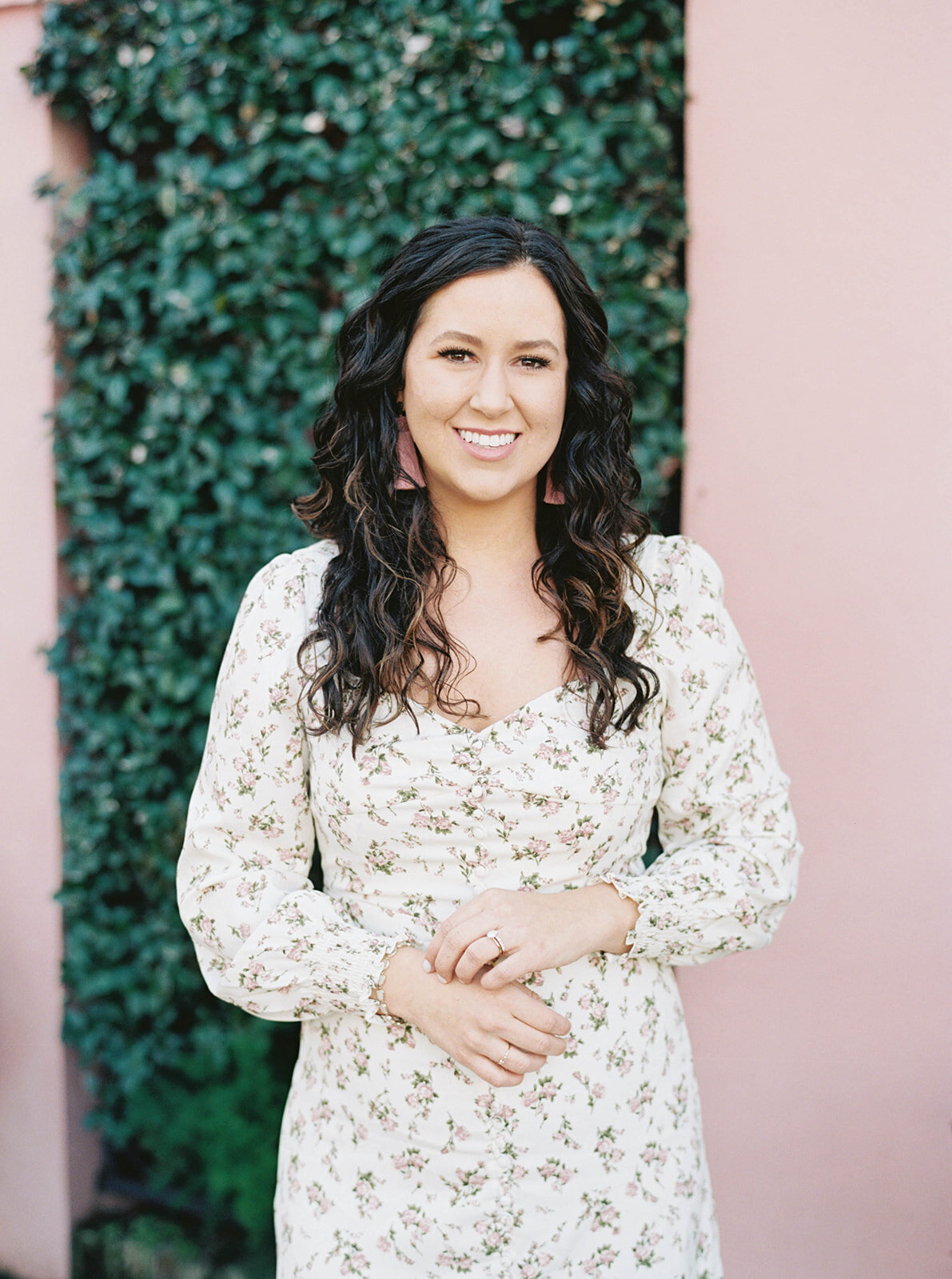 Madison Sapp photographed against an ivy-covered pink wall in Savannah